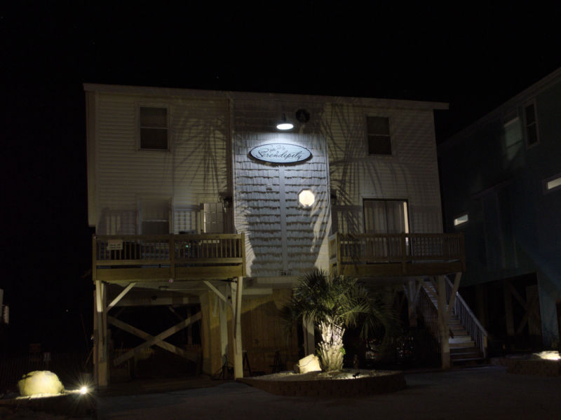 Beach house illuminated at night