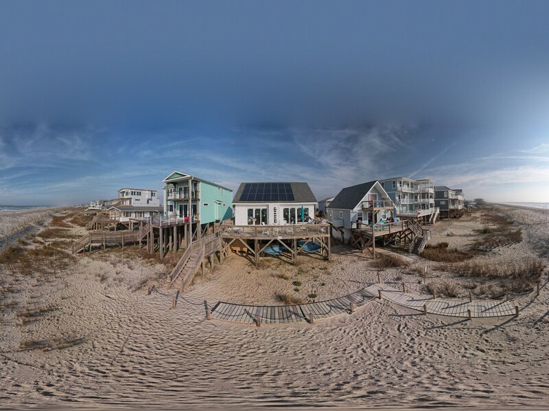 Aerial neighborhood context view of the oceanfront home