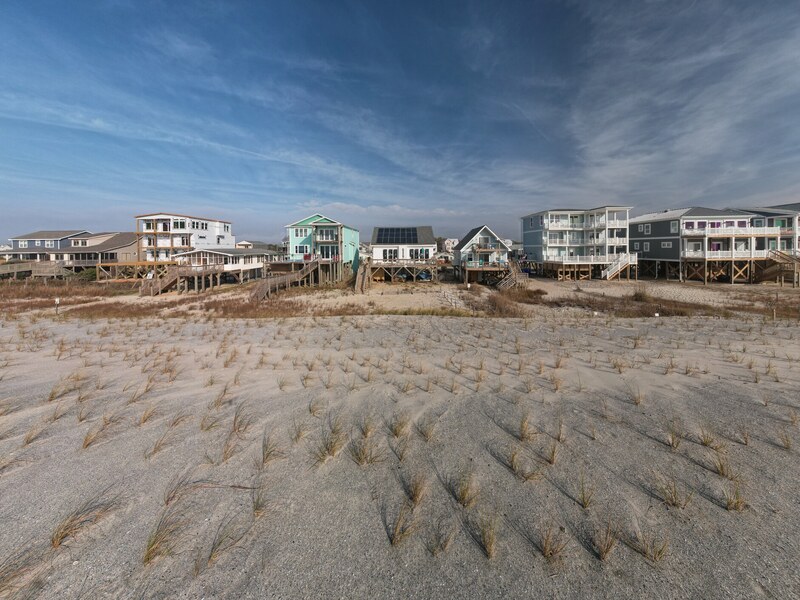 Broad aerial perspective of the home and beachfront row