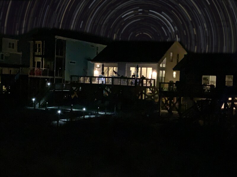 House glowing beneath a clear night sky