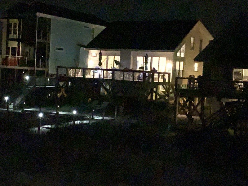 Nighttime exterior view with reflections across the water