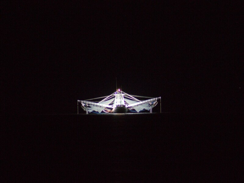 Shrimp boat lights offshore at night