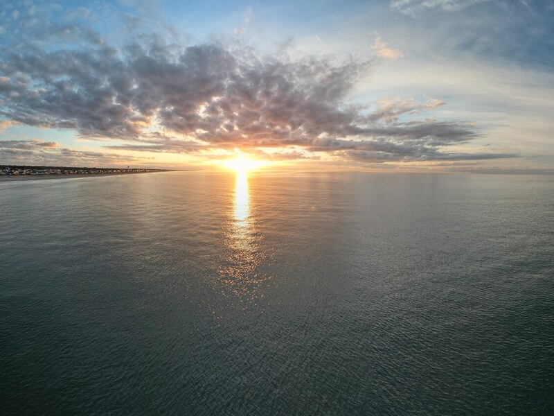 Sunburst spreading across the ocean horizon