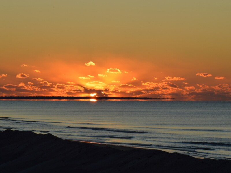 Sunrise over a cloudbank on the water