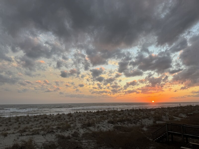 Layered sunset clouds over the coast