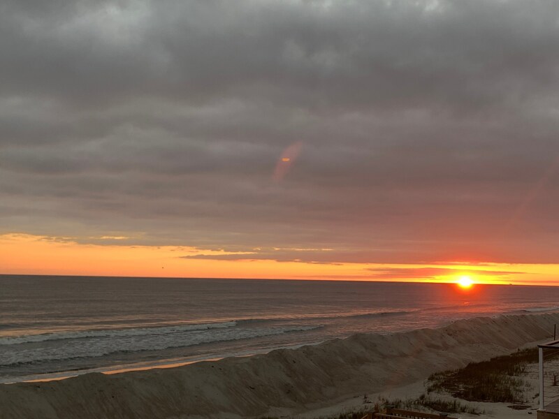Second solar disc sunset over the coast