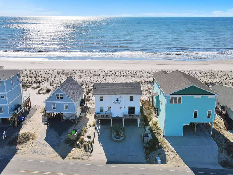 Aerial exterior view showing the home near the shoreline